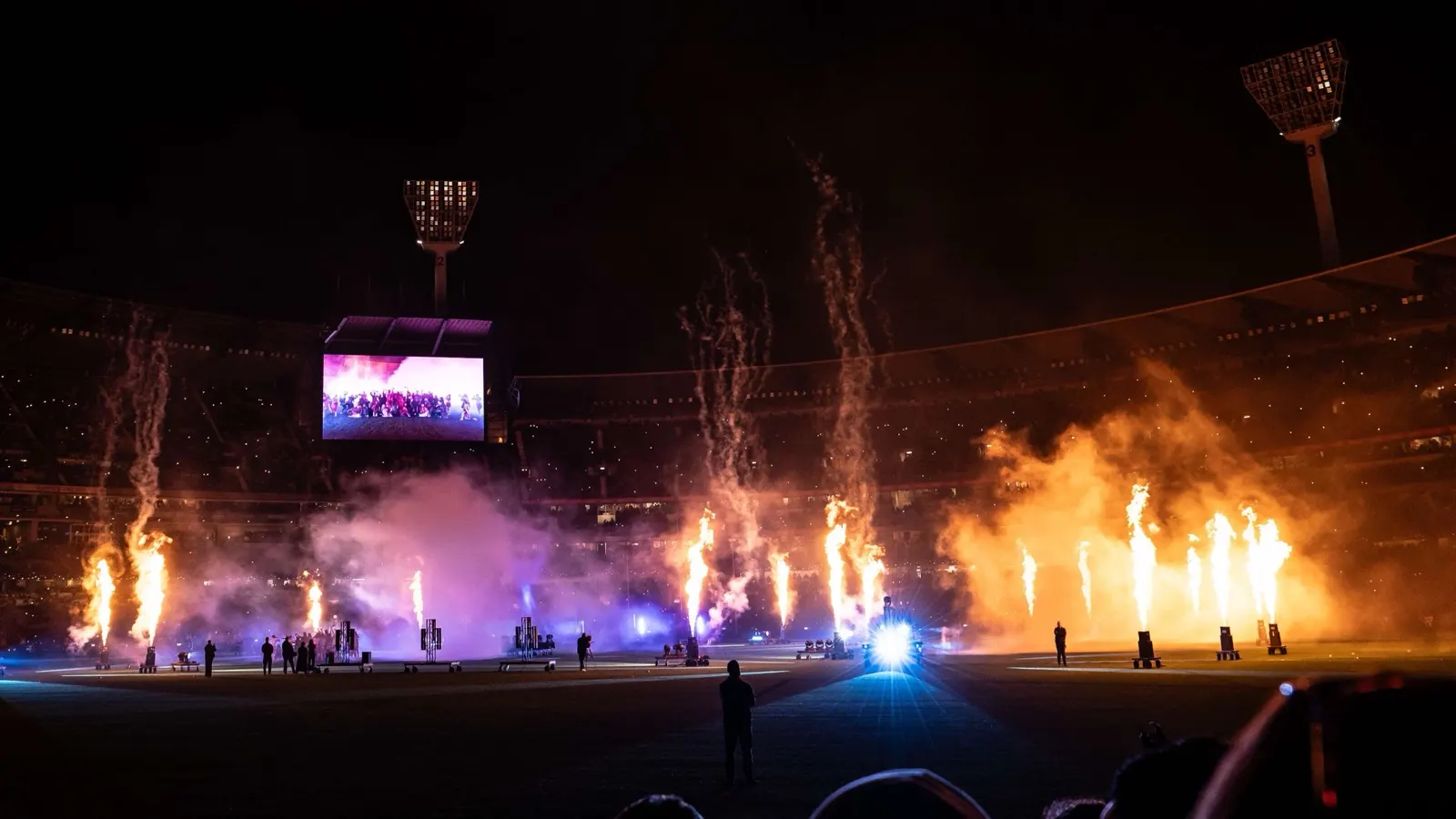 Flames and fireworks light up the MCG at night during the Grand Final pre-game show